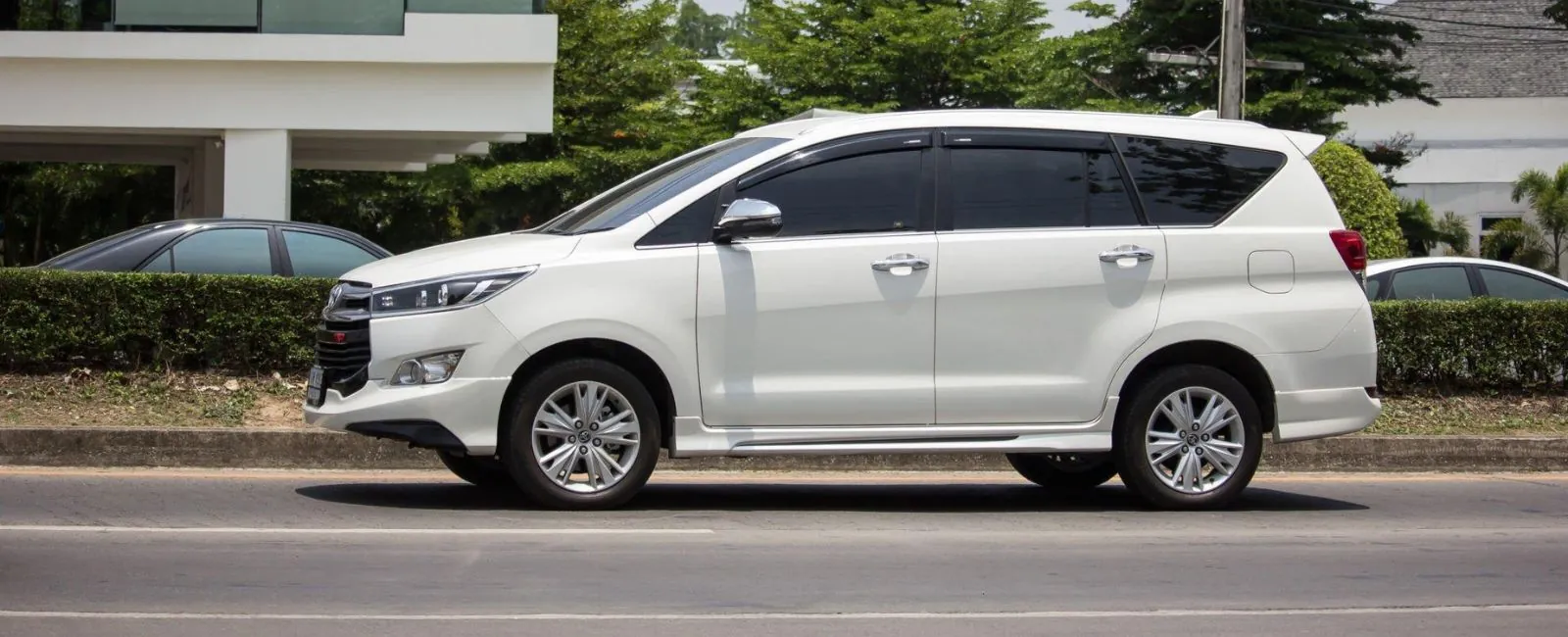 White Innova Crysta driving on a highway – outstation cab from Chennai