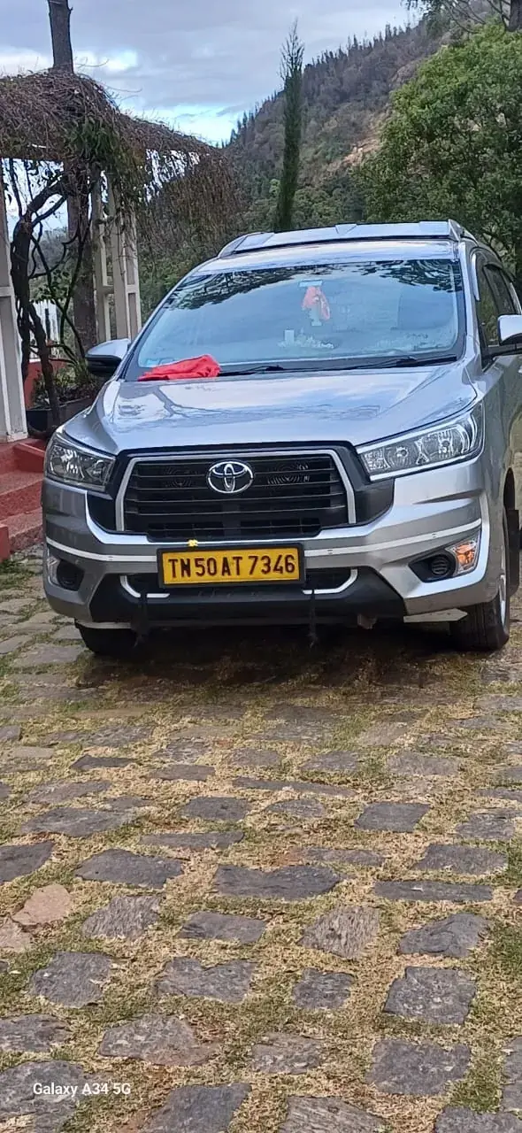 Innova Crysta parked on a hill road during an outstation trip from Chennai