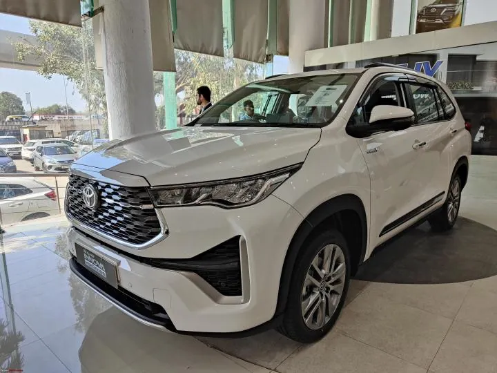 Brand-new white Innova Hycross at a Toyota showroom