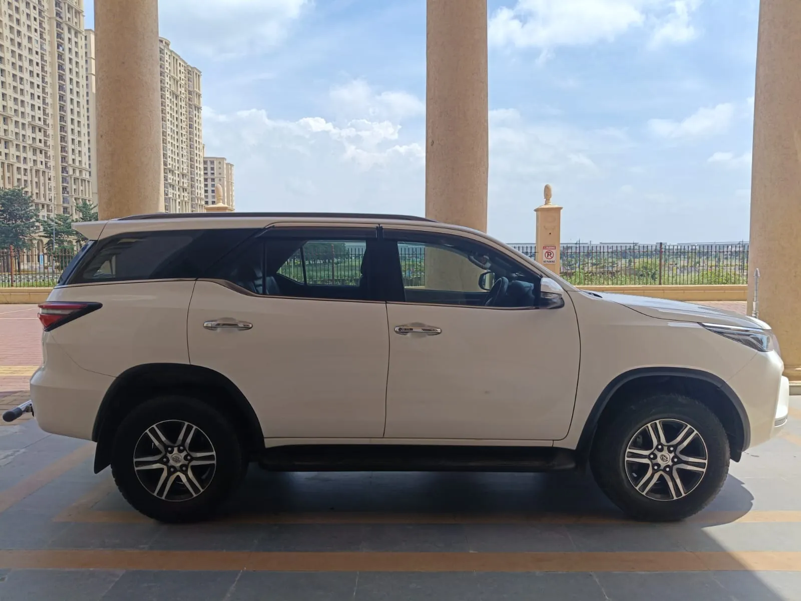 Side view of a white Toyota Fortuner from the Sri Meenakshi Travels fleet at a Chennai venue