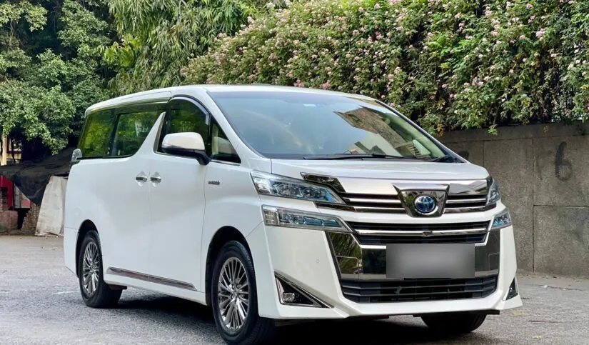 White Toyota Vellfire hybrid three-quarter view parked outdoors